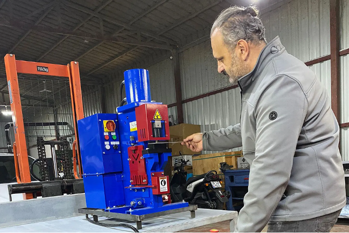 man holding gray steel frame